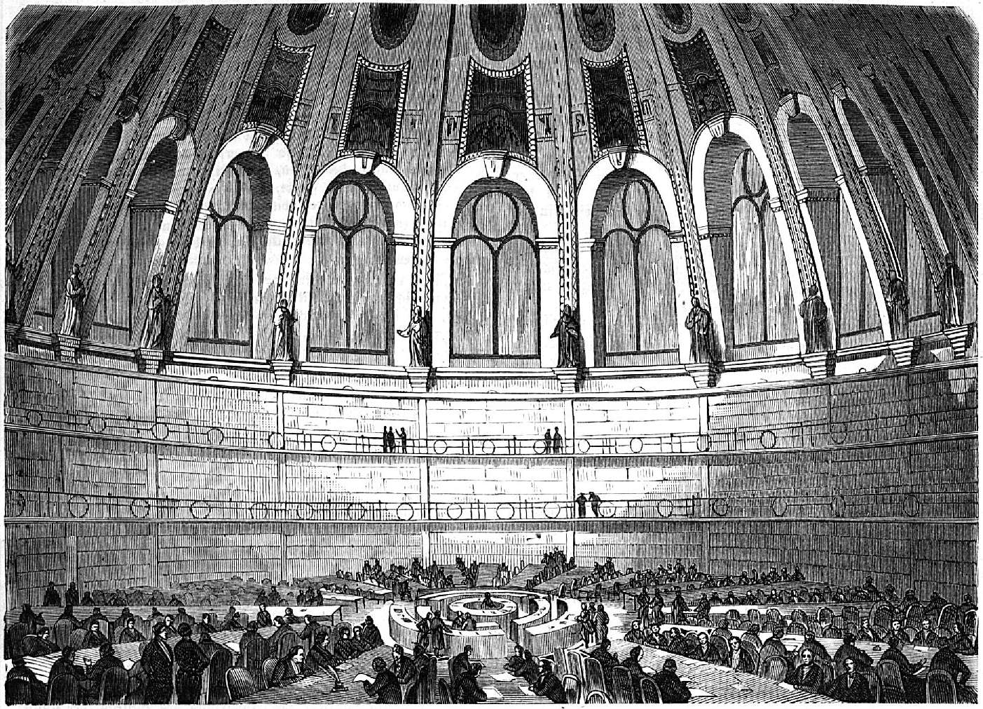 Engraving of the British Museum Reading Room — a vast circular hall with a domed ceiling, radial reading desks, and shelves of books rising along the walls.